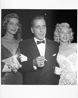 Prints of Actors Marilyn Monroe and Humphrey Bogart and Lauren Bacall attend the premiere of her movie How To Marry A Millionaire on November 4, 1953 in Los Angeles, California The Essence of Cool: How To Marry A Millionaire