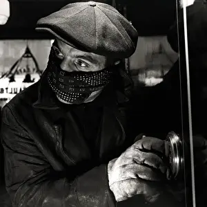 Masked Man Cracking a Safe