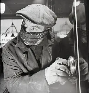 Masked Man Cracking a Safe