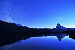 Reflected Gallery: Matterhorn with Milky Way reflected in lake Stellisee, at night, Valais Alps, Canton of Valais