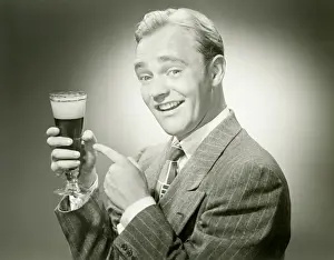 Full Suit Prints: Mature man holding drink, smiling, portrait