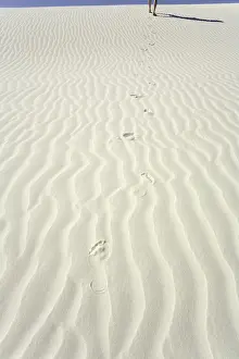 Low Section Prints: Mature man leaving footprints on white gypsum sand dune, low section