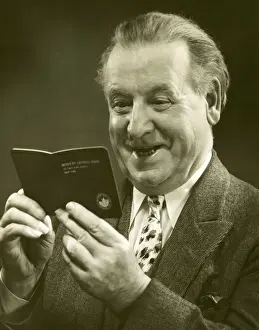 Mature man looking at a bank account booklet