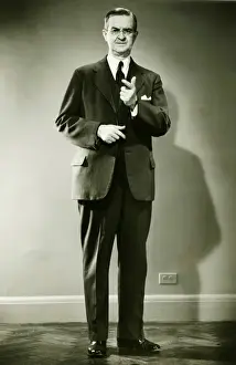 50 59 Years Prints: Mature man pointing in studio, (B&W), portrait