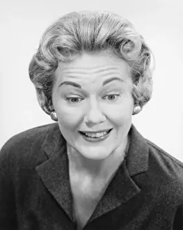 Mature woman posing in studio, (B&W), portrait