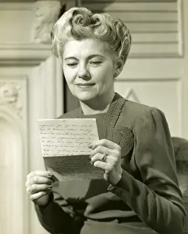 Mature woman reading letter