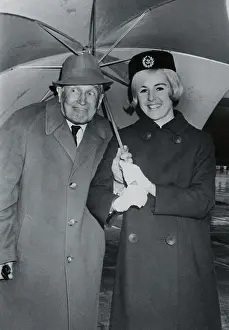 Maurice Chevalier Posing with a Flight Attendant