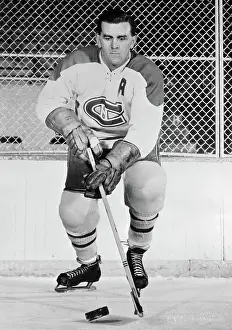 Prints of (Photo by Bettmann Archive/Getty Images) Frozen Moments: A Journey Through Hockey History: Maurice Richard Standing with Hockey Puck