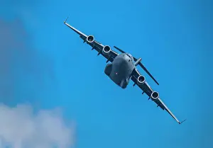Airplane Prints: McDonnell Douglas/Boeing C-17 Globemaster III American Air Force cargo plane flying against sky