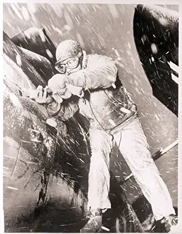 Blizzard Prints: Mechanic Working on Plane in Snowstorm