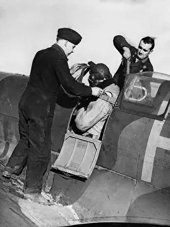Mechanics Assisting Pilot Before His Takeoff