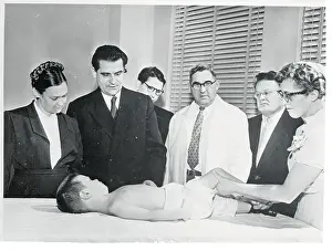 Medical Specialist Observing Young Polio Victim on Table