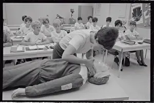 Medical Trainee Bending over Dummy on Table