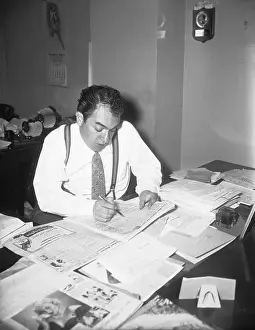 Mel Allen Reading a Newspaper
