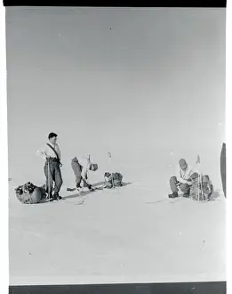 Men Adjusting Their Skis