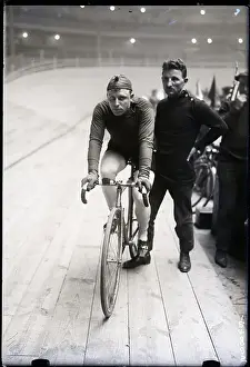 Two Men One On A Bike Other Standing