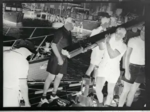 Men Carrying Boom Near Boat Dock