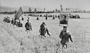 Men Carrying Placards of Chairman Mao Walking in Field