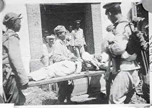 Men Carrying a Wounded Soldier on a Stretcher