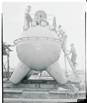 Men Climbing Aboard a Submarine