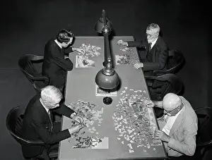 Men Concentrating on Jig-Saw Puzzles