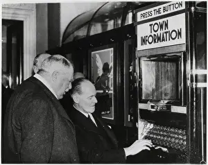 Men Demonstrating Automatic Info Machine