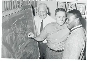 Men Diagramming a Football Play