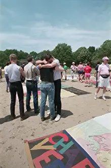 Aids Prints: Two Men Embracing Near Memorial Quilt