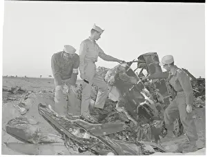 Men Examining Wreckage