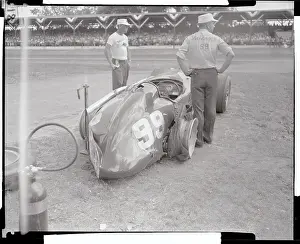 Men Gazing at Wrecked Race Car
