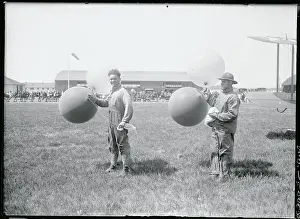 Men Holding Balloons at Aviation Meet
