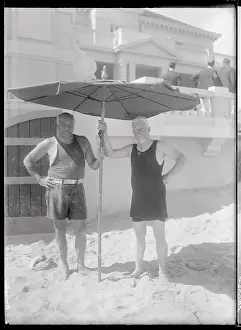 Two Men Holding a Beach Umbrella