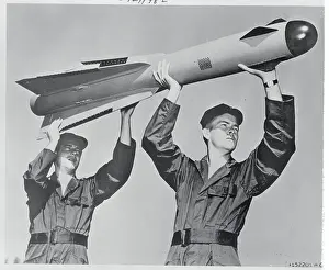 Two Men Holding a Falcon Missile
