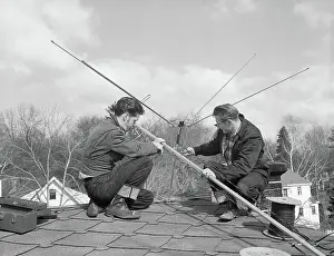 Installing Prints: Men Installing TV Antenna