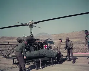 Panmunjom Prints: Men Loading POW Soldier Aboard Helicopter