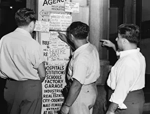Posting Prints: Men Look At Job Postings At Agency