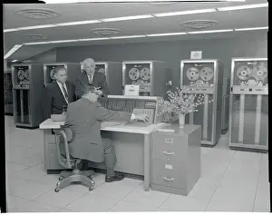 Men Looking Over Computer Printouts