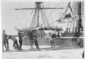 Men Lowering a Motor Sledge for Ship