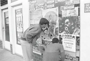 Black Power Prints: Men Observing Bullet Holes in Black Panther Headquarters Window