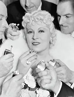 Men Offering to Light Cigarette for Mae West