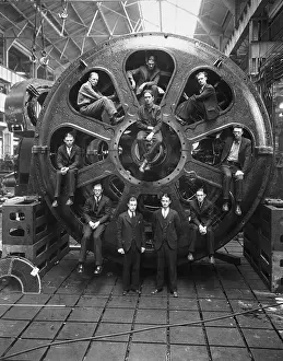 Men Perched Inside Huge Motor