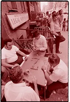 Men Play Dominoes on Sidewalk