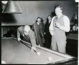 Men Playing Billiards While Others Watch