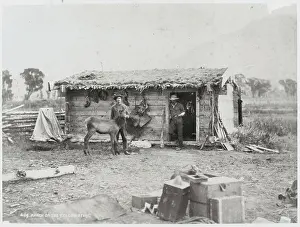 Men Posing Outside Cabin