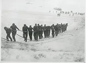 Hard Prints: Men Pulling Cable on Shoreline