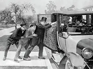 Overweight Prints: Men Pushing Stout Woman into Automobile