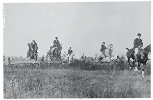 Men Riding Horseback and Jumping Fence on Hunt