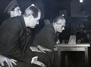 Men Seated Leaning Toward Loudspeaker