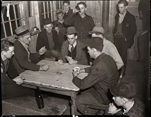 Men Seated at Table Playing Cards