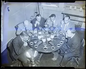 Men Sitting at Round Table Tasting Tea